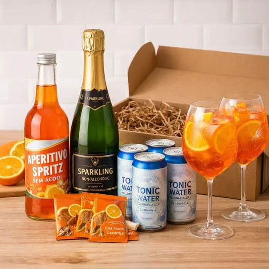 Aperol Spritz sem álcool em taça com espumante Veuve du Vernay e latas de tônica Wewi ao lado.